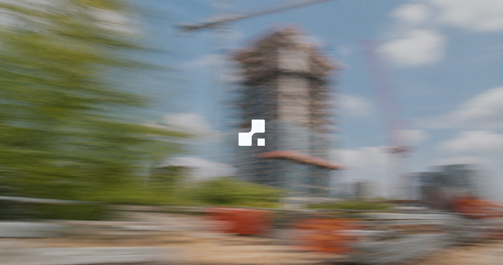 Motion-blurred summer view of a high-rise tower under construction with cranes and green trees, overlaid with the Aplon mark