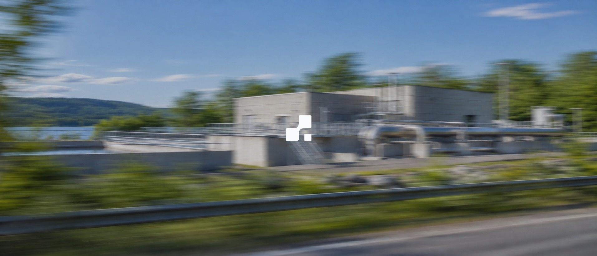 Municipal treatment station with exterior steel pipes, blurred by lateral camera movement, with the Aplon mark